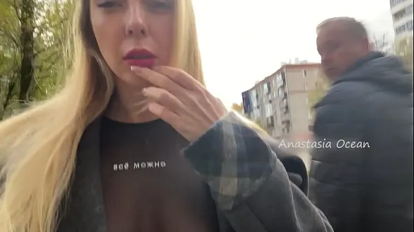 A girl shows her breasts while walking in public in the city 드라이브 동영상 표시